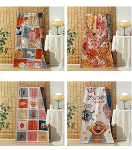 Detail shot of four-layer cotton gauze towels with vintage floral and cartoon IP patterns