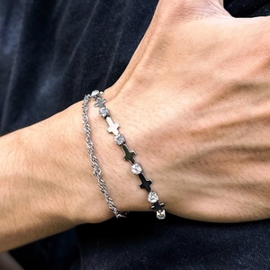 Close-up of double-layer titanium steel cross bracelet with zircon for men