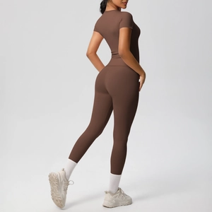 Close-up of seamless dark coffee high-waisted yoga pants and short sleeve athletic crop top