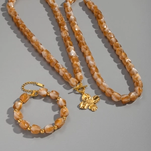 Amber resin bead jewelry set with gold flower pendant necklace and matching bracelet