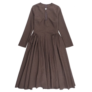Detail of long sleeve coffee dress featuring unique hollow-out neckline and button design