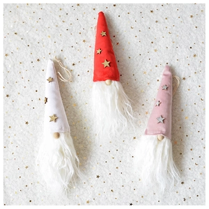 Close-up of three plush Christmas gnomes with wooden noses and golden star accents