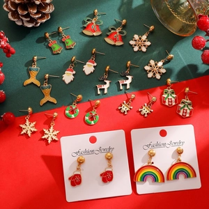 Flat lay of Christmas themed earrings featuring Santa, reindeer and snowflakes motifs