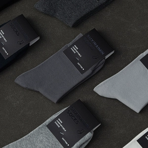 Premium men's solid cotton business socks in assorted colors on dark textured background