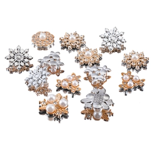 Flat lay of pearl and rhinestone floral DIY accessories in gold and silver finishes
