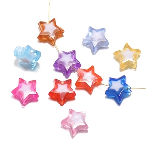 Macro shot of colorful acrylic star beads with golden thread for DIY phone chains