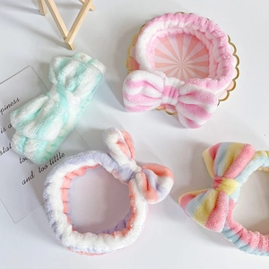 Detail of colorful striped coral fleece headbands with large bows for face washing