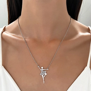 Detailed close-up of a silver ballerina pendant necklace worn by a female model