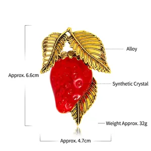 Fashionable strawberry brooch in red artificial crystal with golden alloy leaf detail