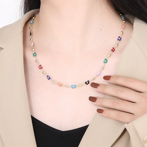 Golden chain necklace with colorful enamel evil eye butterfly pendants on a model