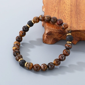 Detailed close-up of tiger eye and lava stone beads on a rustic wood stand
