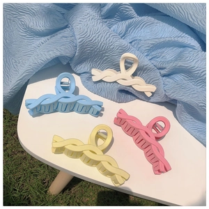 Colorful matte shark hair clips in white blue yellow and pink on a stylish table