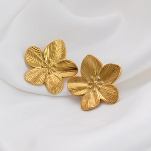 18K gold plated titanium steel flower stud earrings displayed on soft white fabric