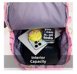 Internal view of the pink backpack showing large capacity for tablets and accessories
