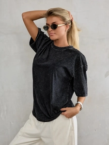 Detail of vintage acid wash texture on dark grey heavy cotton oversized T-shirt