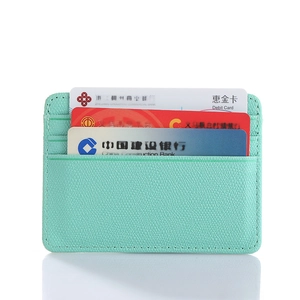Close-up of mint green pebble leather slim wallet with three credit card slots