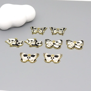 Detailed set of butterfly and skull enamel charms with gold frames for DIY jewelry