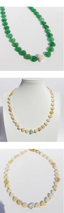 Detail of colorful heart-shaped stone beads and Baroque pearl choker necklaces