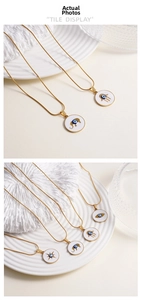 Detail of gold evil eye elephant pendants on snake chains with white enamel coating