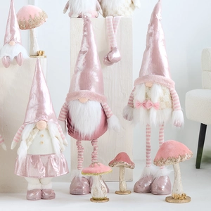 Pink Nordic Christmas gnome dolls with glowing mushrooms for festive window display