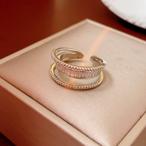 Macro shot of silver multi-layer open ring with rectangular zircon stones and bead edges