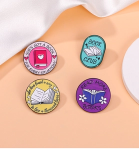 Detail of four colorful enamel book badges with read more books and book club slogans