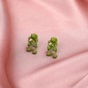 Vintage green frog metal stud earrings on pink silk fabric, minimalist retro animal jewelry