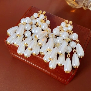Elegant French style teardrop pearl tassel earrings on a vintage leather gift box