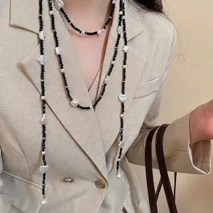 Elegant beaded long necklace featuring black faceted beads and white baroque pearls
