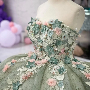 Lush sage green ball gown with 3D floral appliqués and shimmering sequin tulle