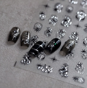 Macro detail of gothic star moon nail art stickers with metallic silver finish
