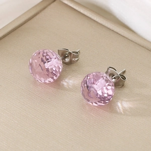 Macro shot of pink faceted crystal stud earrings with silver-tone metal backings