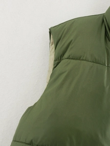 Detailed view of stitching and texture on the green double-sided padded vest