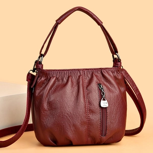 Burgundy pleated handbag with top handle and front zipper pocket in textured leather