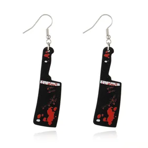 Macro detail of acrylic Halloween cleaver earrings with red blood splatter and black finish