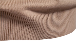 Detailed macro view of the khaki knitted sweater showing ribbed hem and fine fabric texture