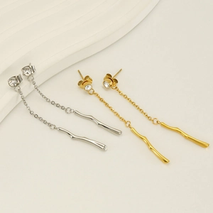 Detailed view of gold and silver bamboo tassel earrings with sparkling round rhinestones