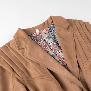 Detail of faux suede jacket featuring pleated shoulders and floral lining