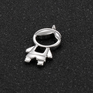 Macro shot of silver hollowed-out cartoon figure pendant with small inlaid diamonds