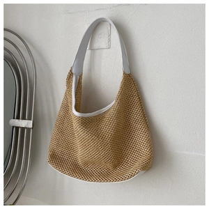 Detail of the woven beige mesh texture and white leather trim on the summer hobo bag