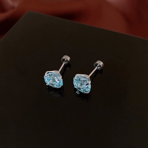 Detail of light blue zircon earrings with silver metal base and secure screw back design