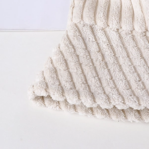 Close-up of cream fuzzy knit fabric showing soft striped texture of the bucket hat