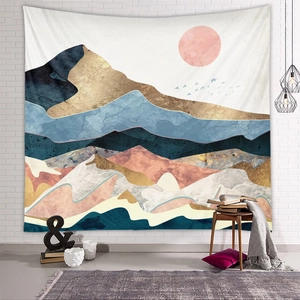 Close-up of abstract mountain tapestry with pink sun hanging on a white brick wall
