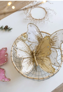 Close-up of sparkling Christmas butterfly clips with sequins and rhinestones in a basket