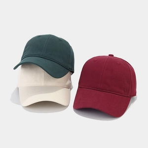 Classic cotton baseball caps in dark green, off-white, and wine red colors