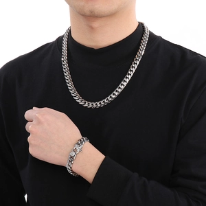 Polished stainless steel Cuban chain necklace and bracelet set for men on a model