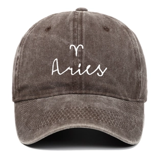 Detailed close-up of white Aries zodiac embroidery on vintage washed cotton baseball cap