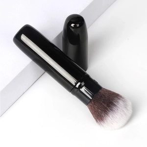 Retractable black makeup brush with dual-tone synthetic bristles for powder and blush