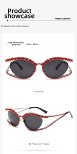 Detail view of Y2K cat-eye sunglasses with luxury red rhinestone decor and dark gray lenses