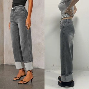 Detail view of high waisted dark grey wide leg jeans with vintage cuffed hems